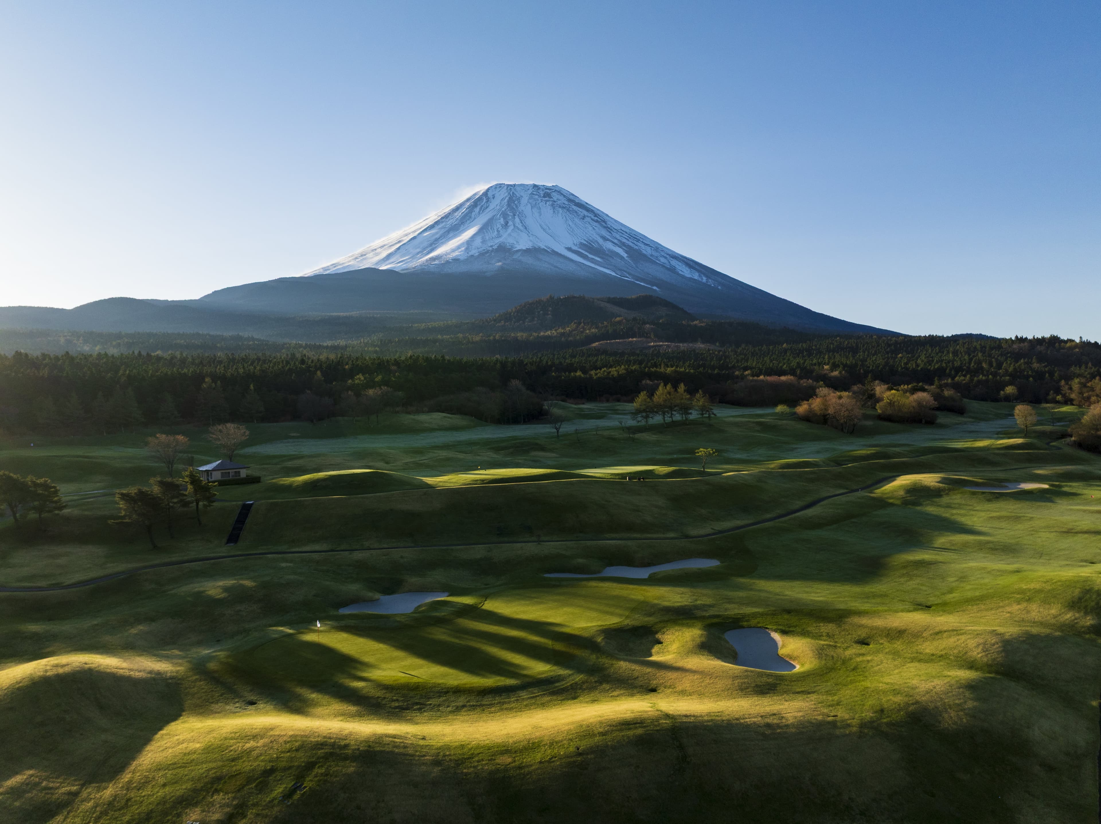 Hole 4 at Fuji Classic — rolling fairway and bunkers with Mt. Fuji towering behind