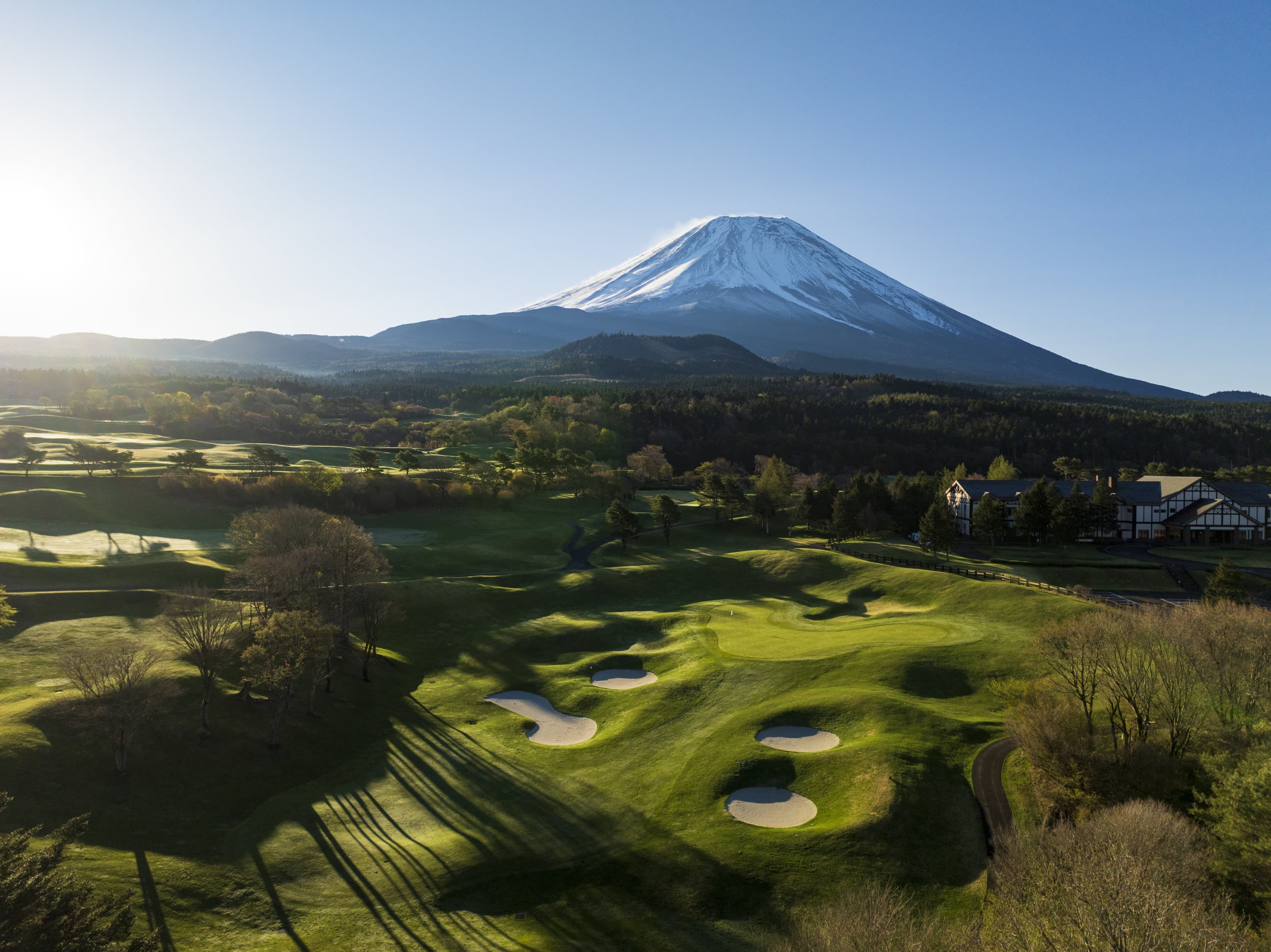 Hole 9 at Fuji Classic — fairway running toward the clubhouse beneath Mt. Fuji