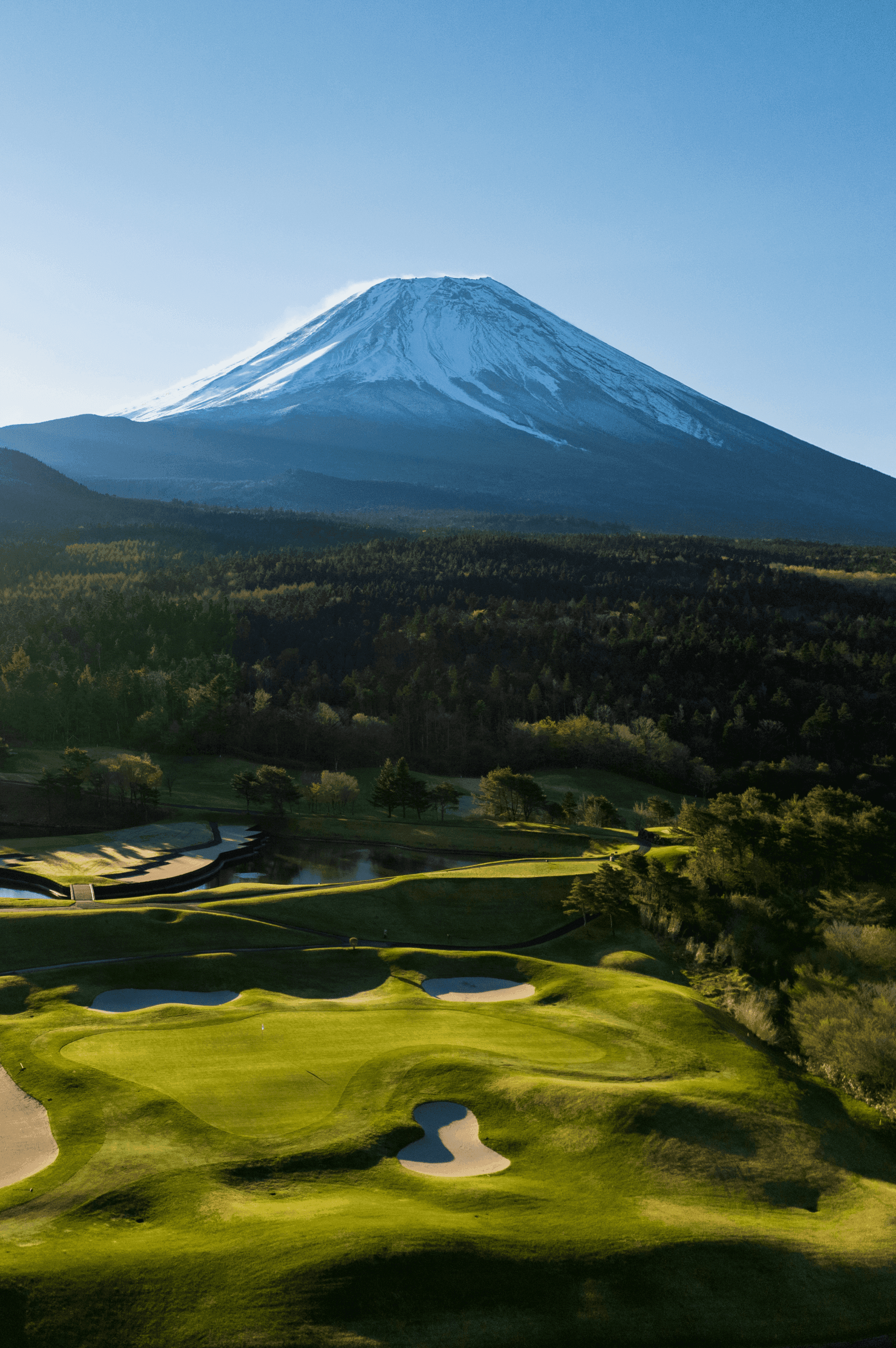 Hole 16 at Fuji Classic — the course unfolding beneath the full height of Mt. Fuji