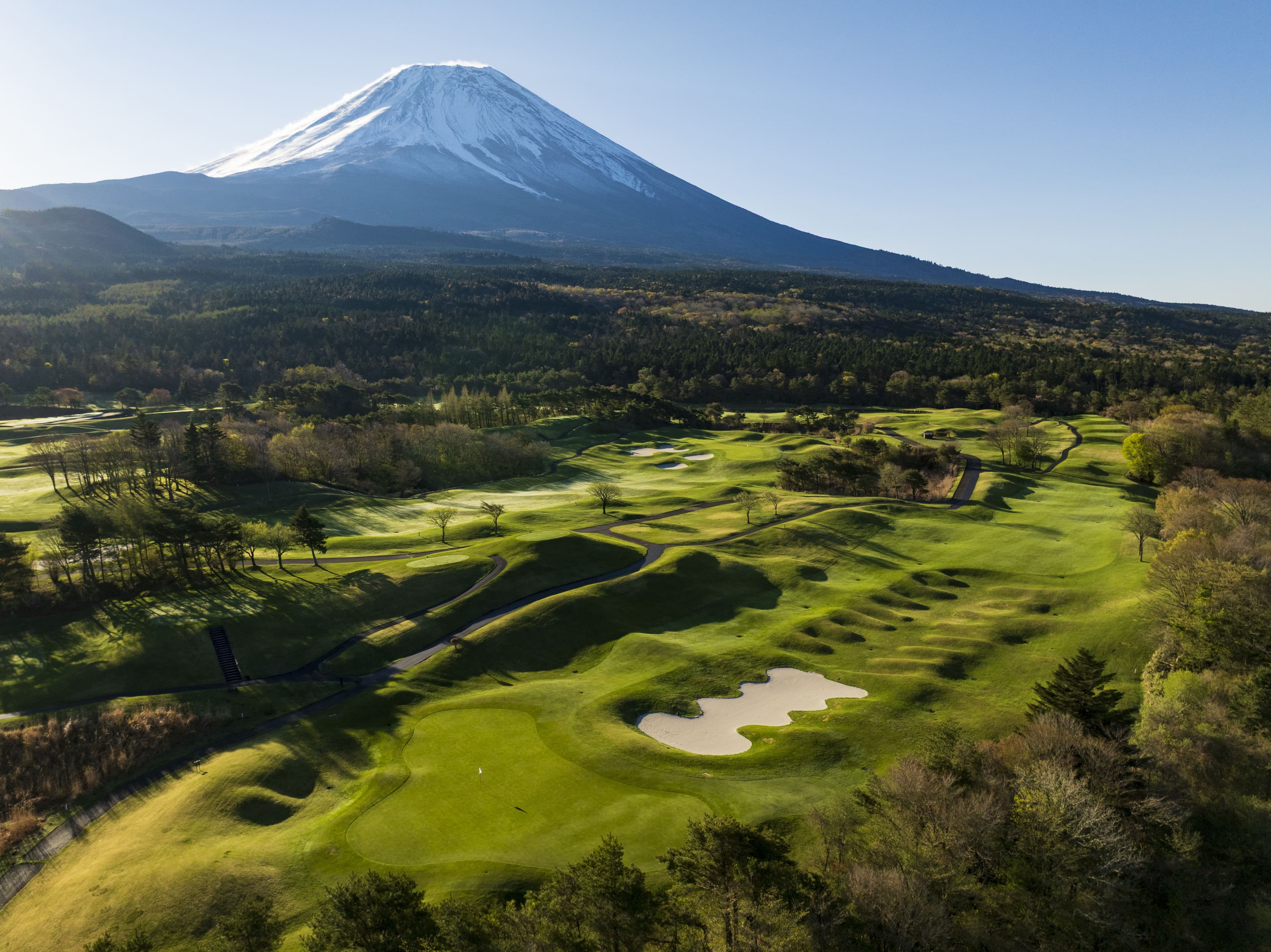 Hole 12 at Fuji Classic — panorama of bunkered fairways below Mt. Fuji
