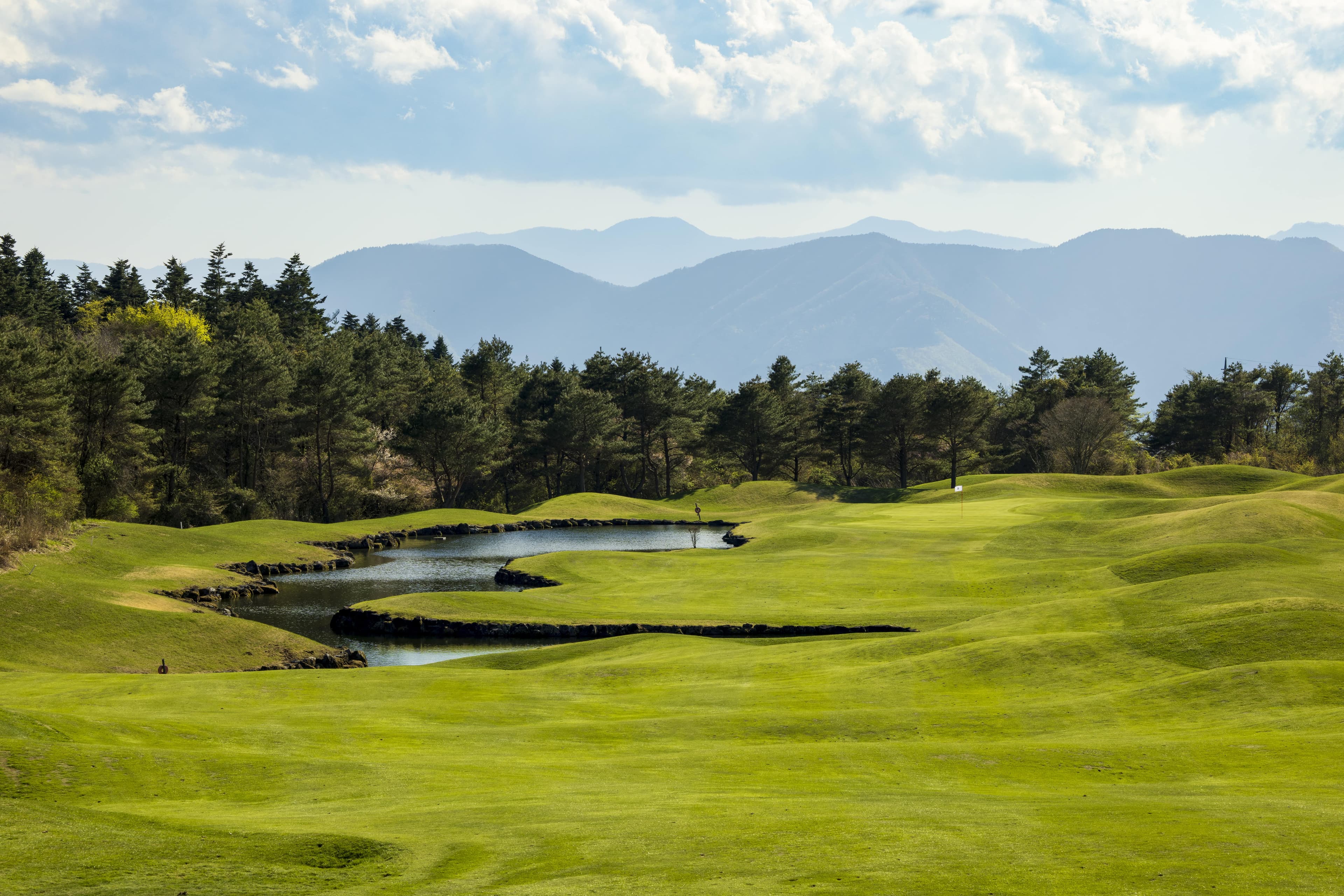 Hole 11 at Fuji Classic — stream-fed ponds cutting across the approach to the green