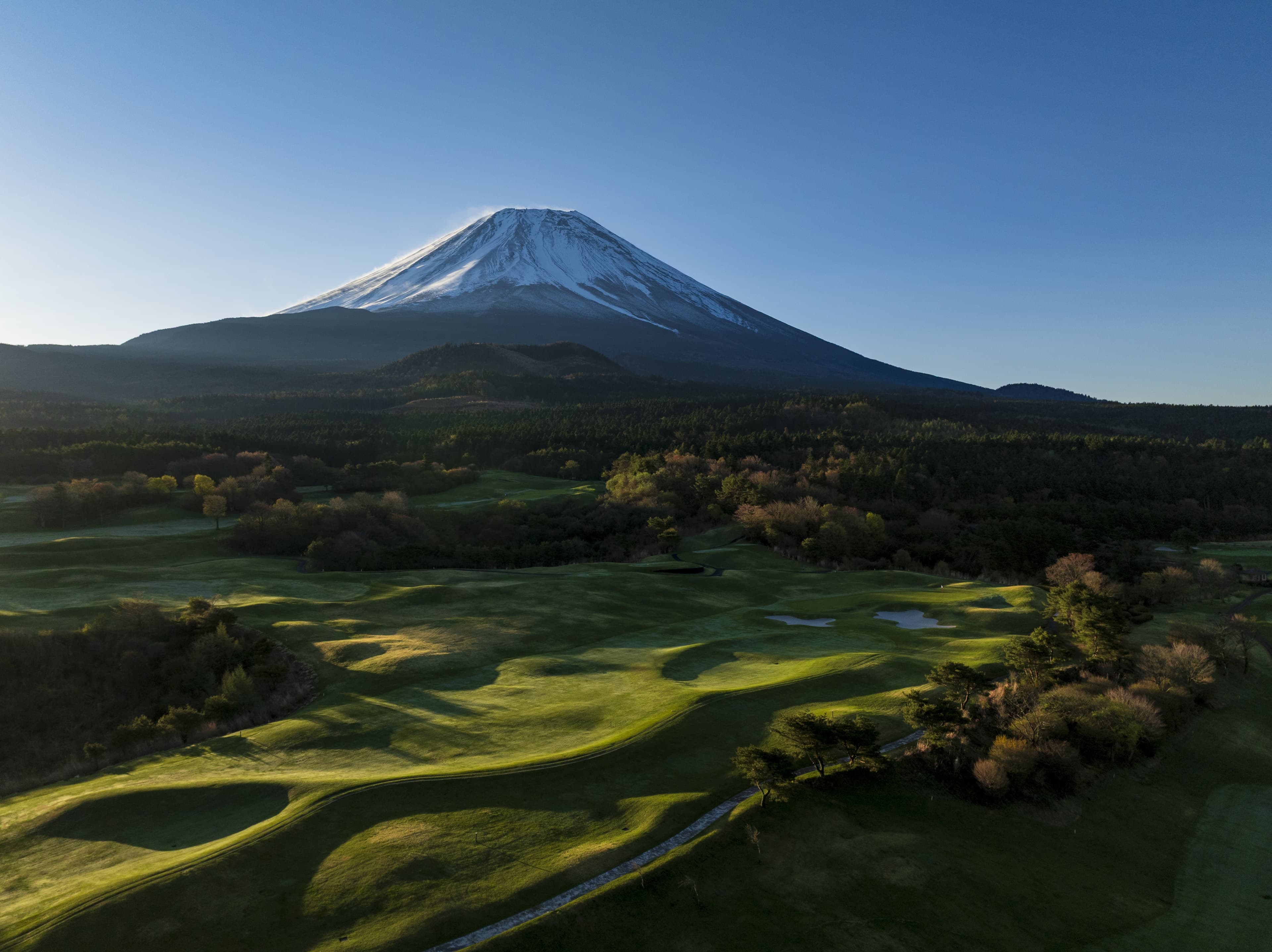 Snow-capped Mount Fuji rising above the course at dawn